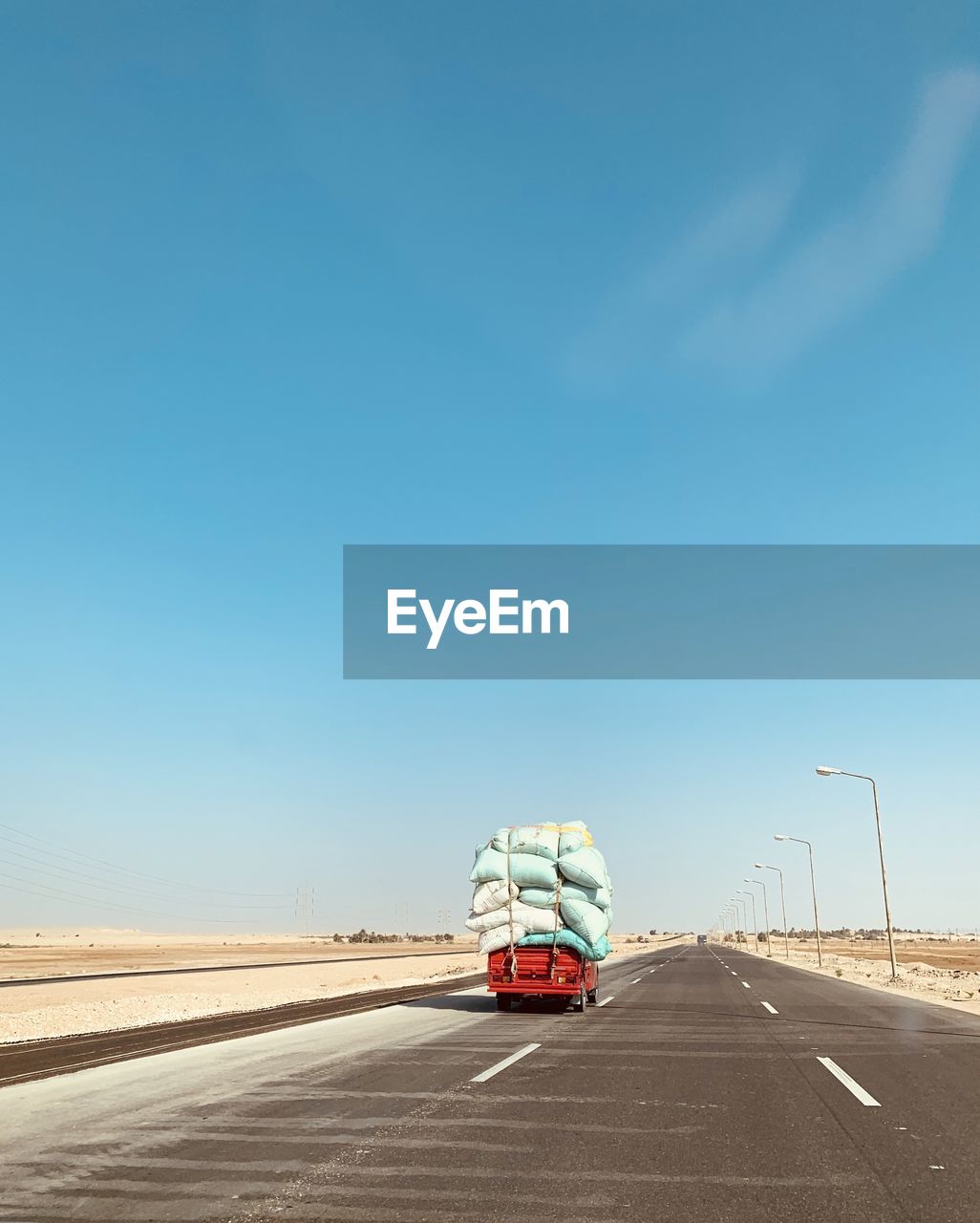 CARS ON HIGHWAY AGAINST BLUE SKY