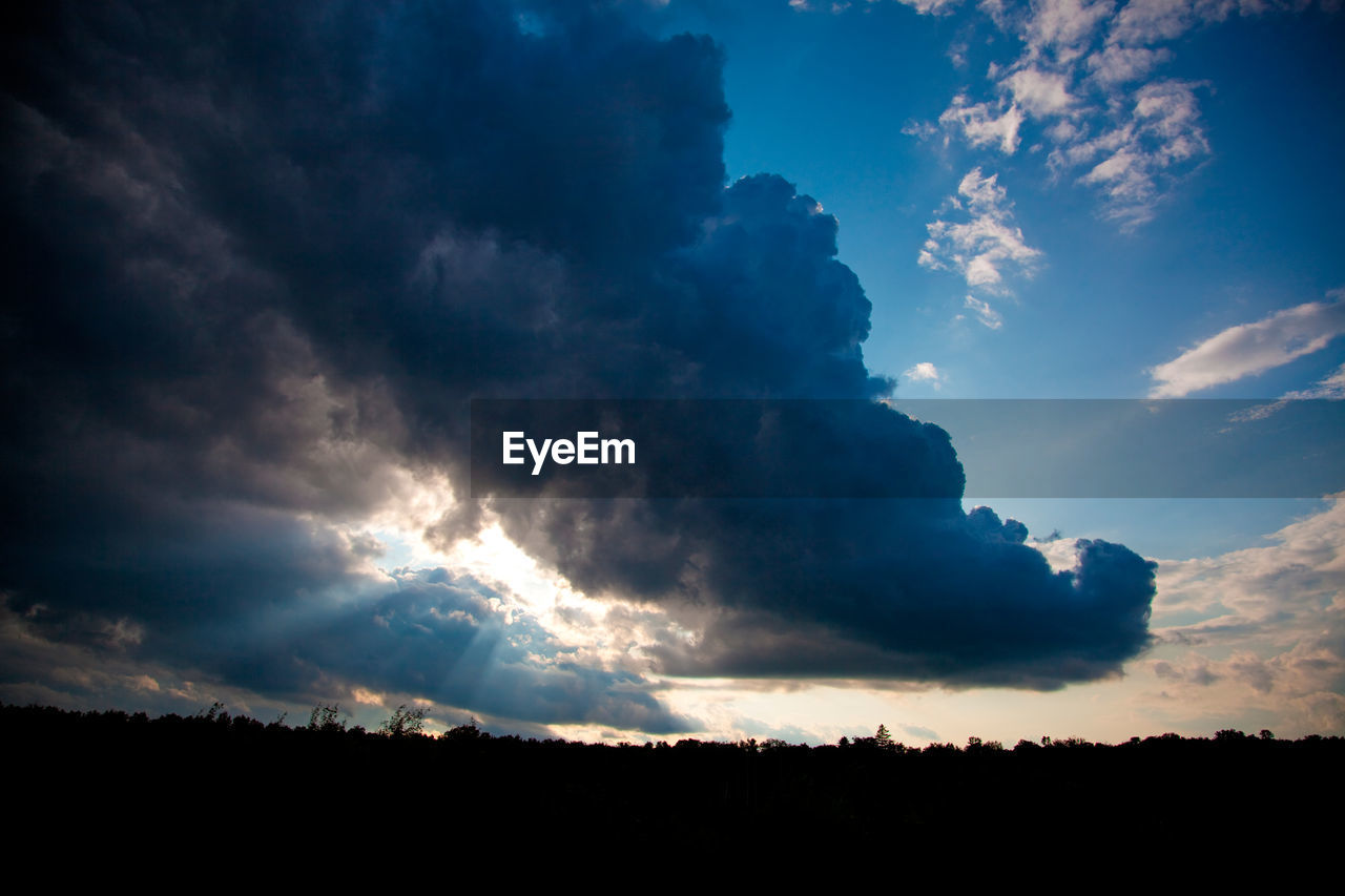 Low angle view of cloudy sky against sunset