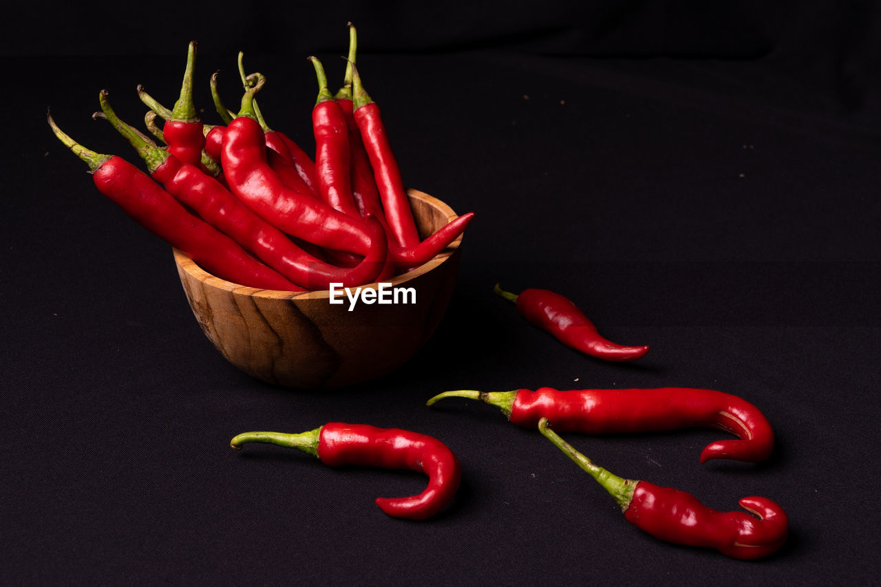 CLOSE-UP OF RED CHILI PEPPER ON TABLE