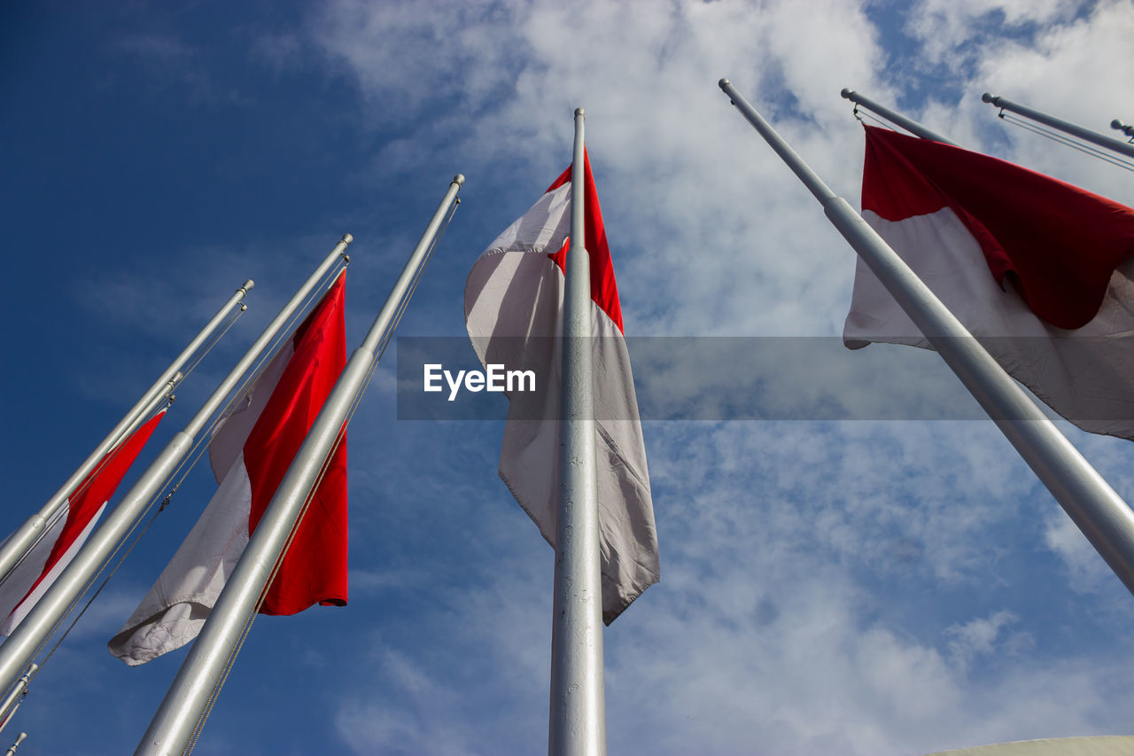 flag, blue, sky, patriotism, cloud, mast, wind, nature, red, environment, low angle view, no people, pole, day, outdoors, group of objects