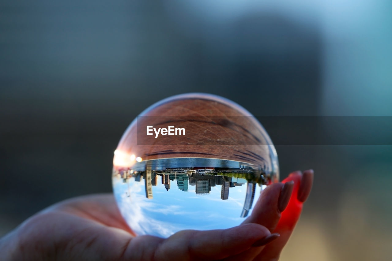 Cropped image of woman holding crystal ball