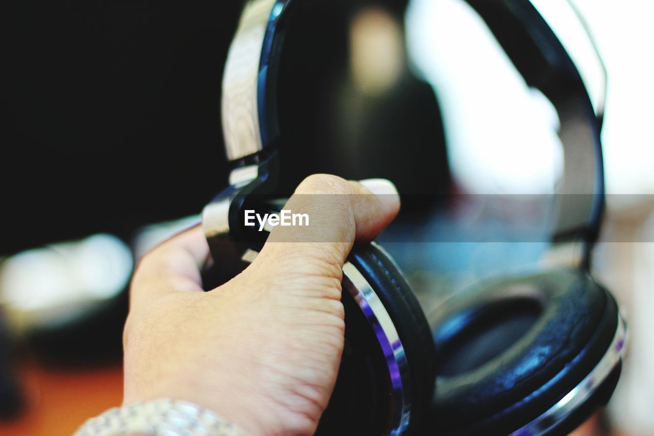 Close-up of hand holding headphones