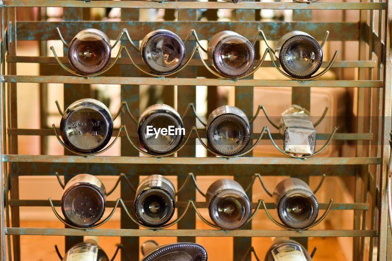 Close-up of wine bottles arranged on shelves