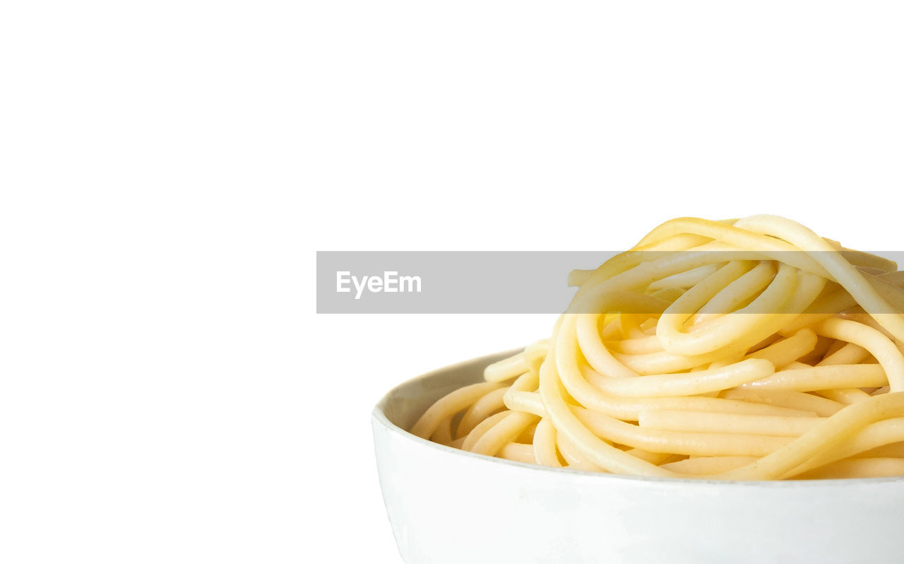 CLOSE-UP OF NOODLES AGAINST WHITE BACKGROUND