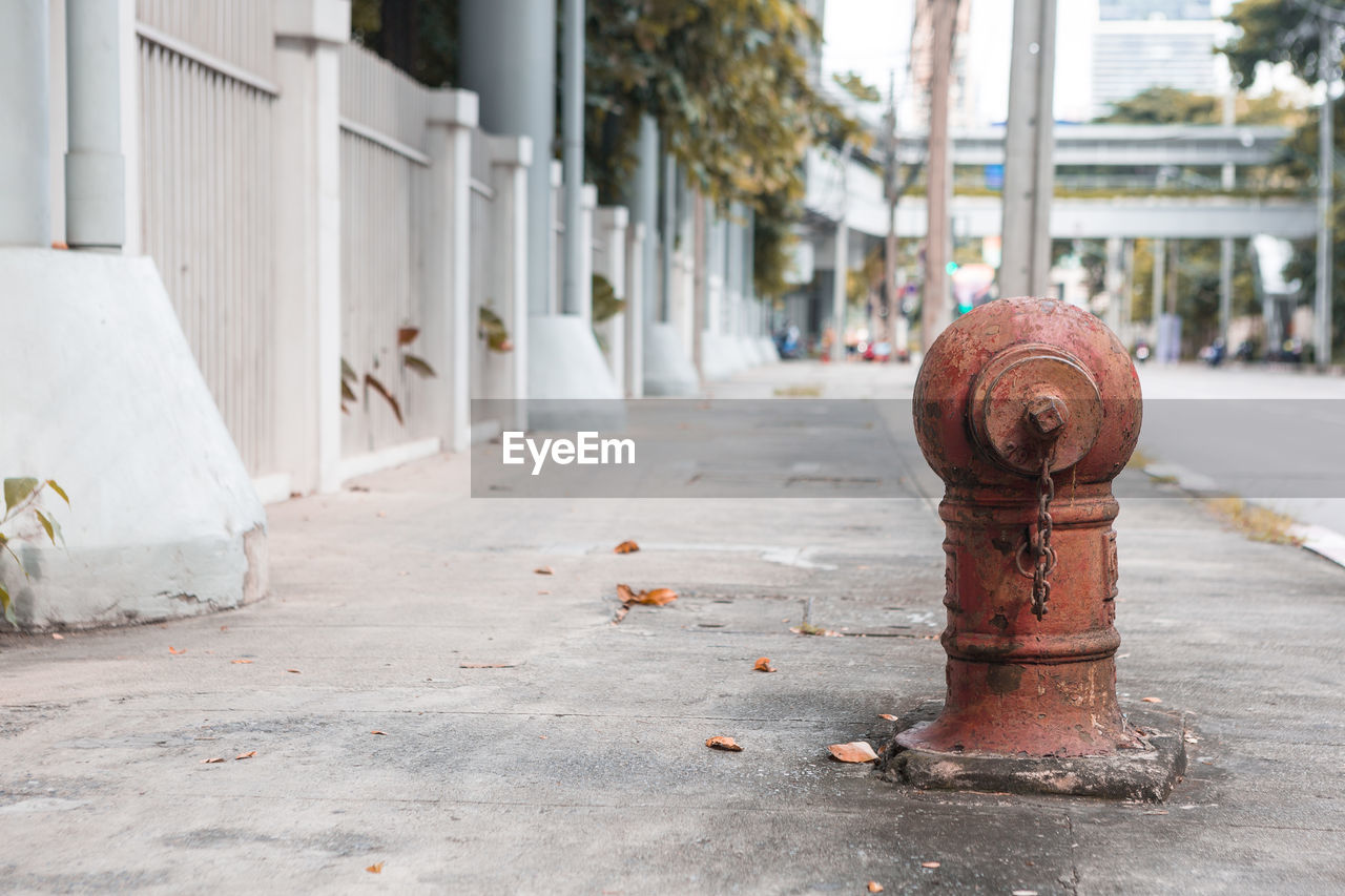 FIRE HYDRANT ON SIDEWALK BY BUILDING