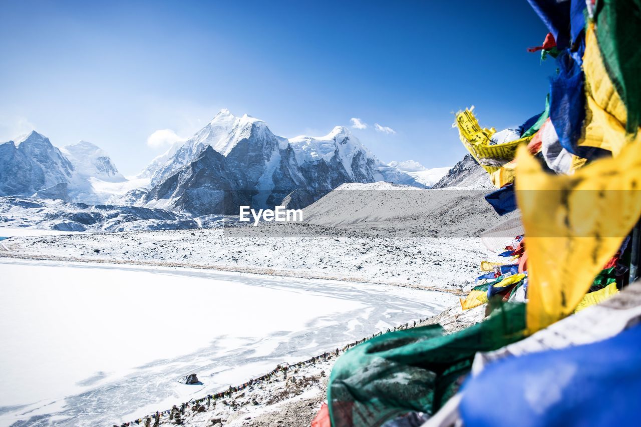 Snow covered mountains against blue sky