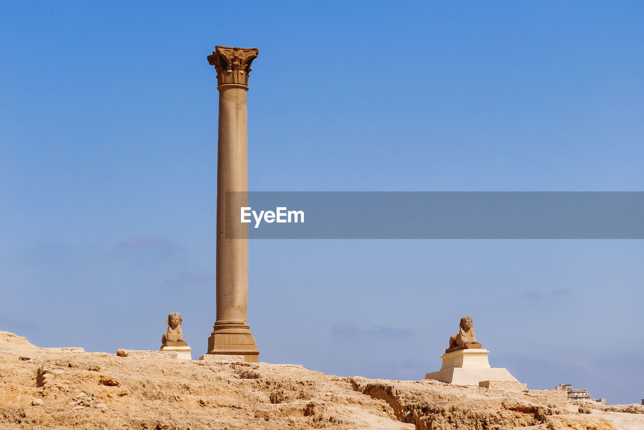 Pompey pillar, roman triumphal column, two sphinx statues at the serapeum of alexandria. egypt.