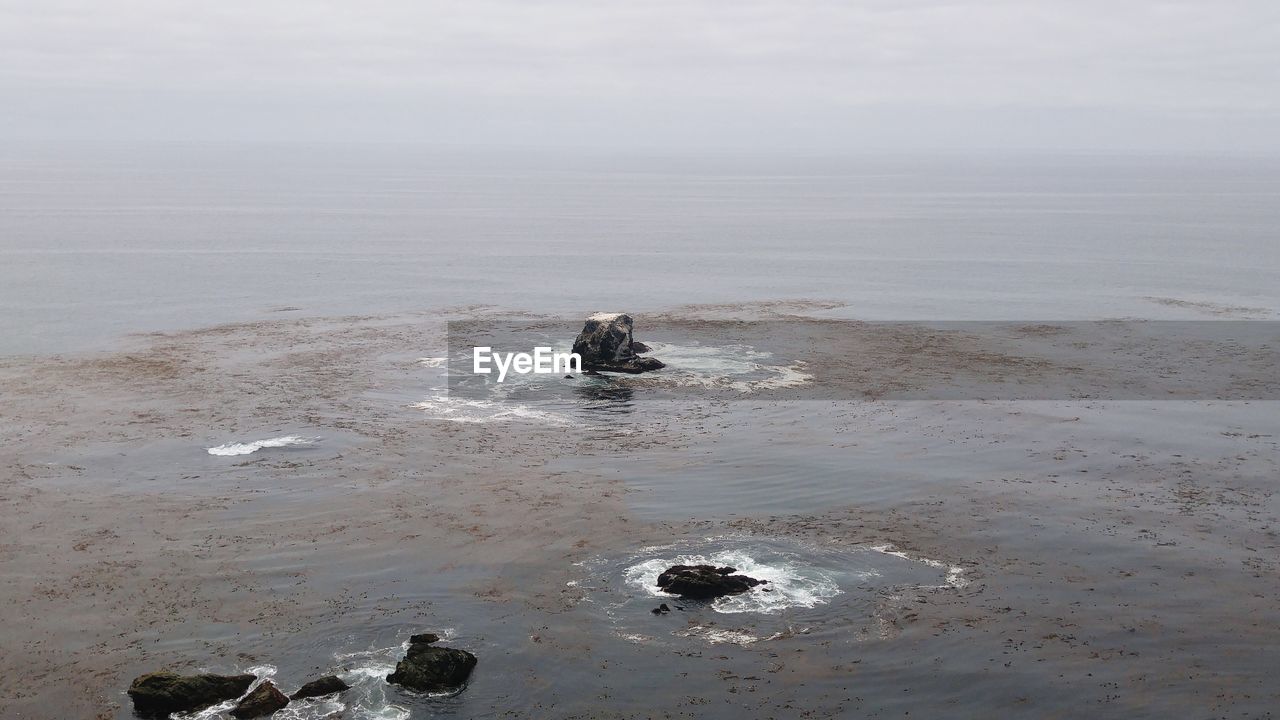 High angle view of rock formations in sea