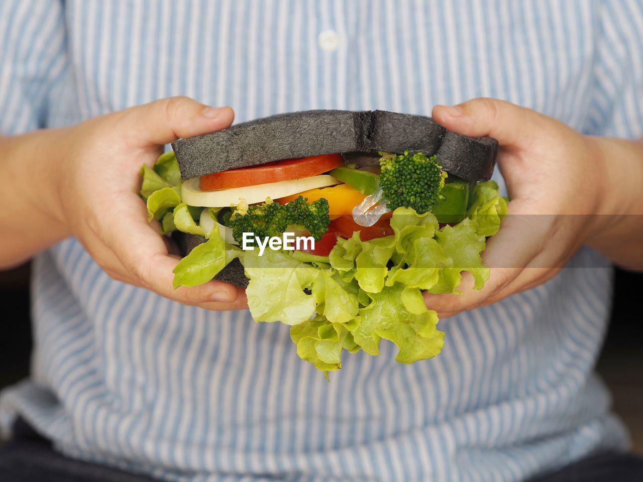 food, food and drink, healthy eating, vegetable, wellbeing, hand, one person, holding, adult, freshness, midsection, fast food, salad, lifestyles, lettuce, indoors, eating, women, produce, close-up, meal, men, dish, fruit, organic, casual clothing, green, vegetarian food, front view, dieting, lunch, avocado