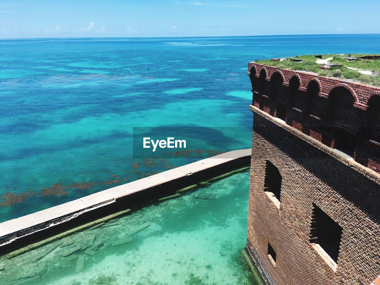 HIGH ANGLE VIEW OF SWIMMING POOL BY SEA