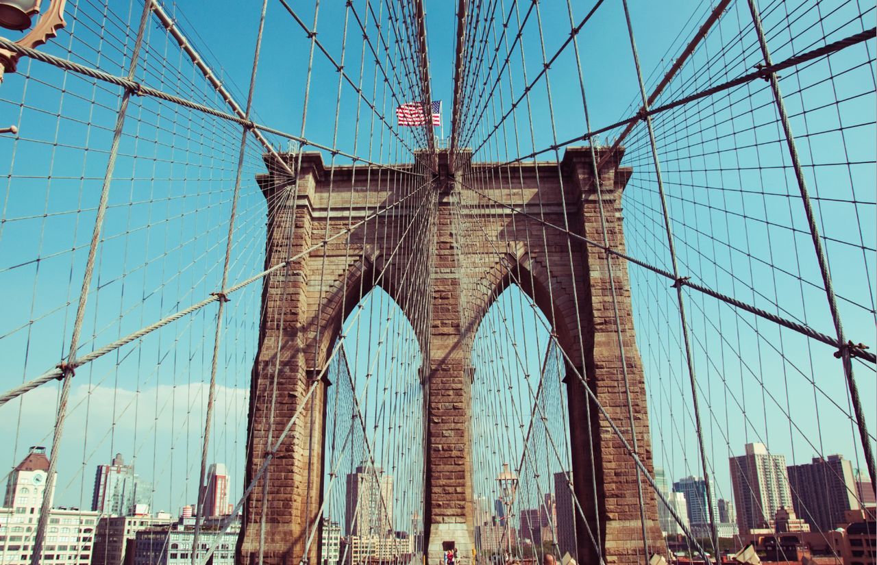 Low angle view of suspension bridge against sky