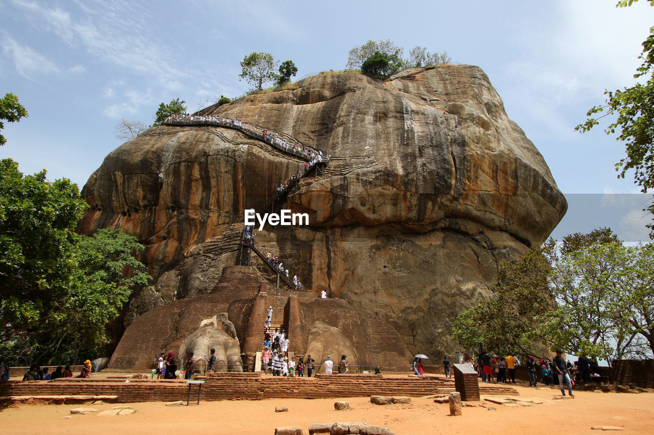 People climbing on rock formation