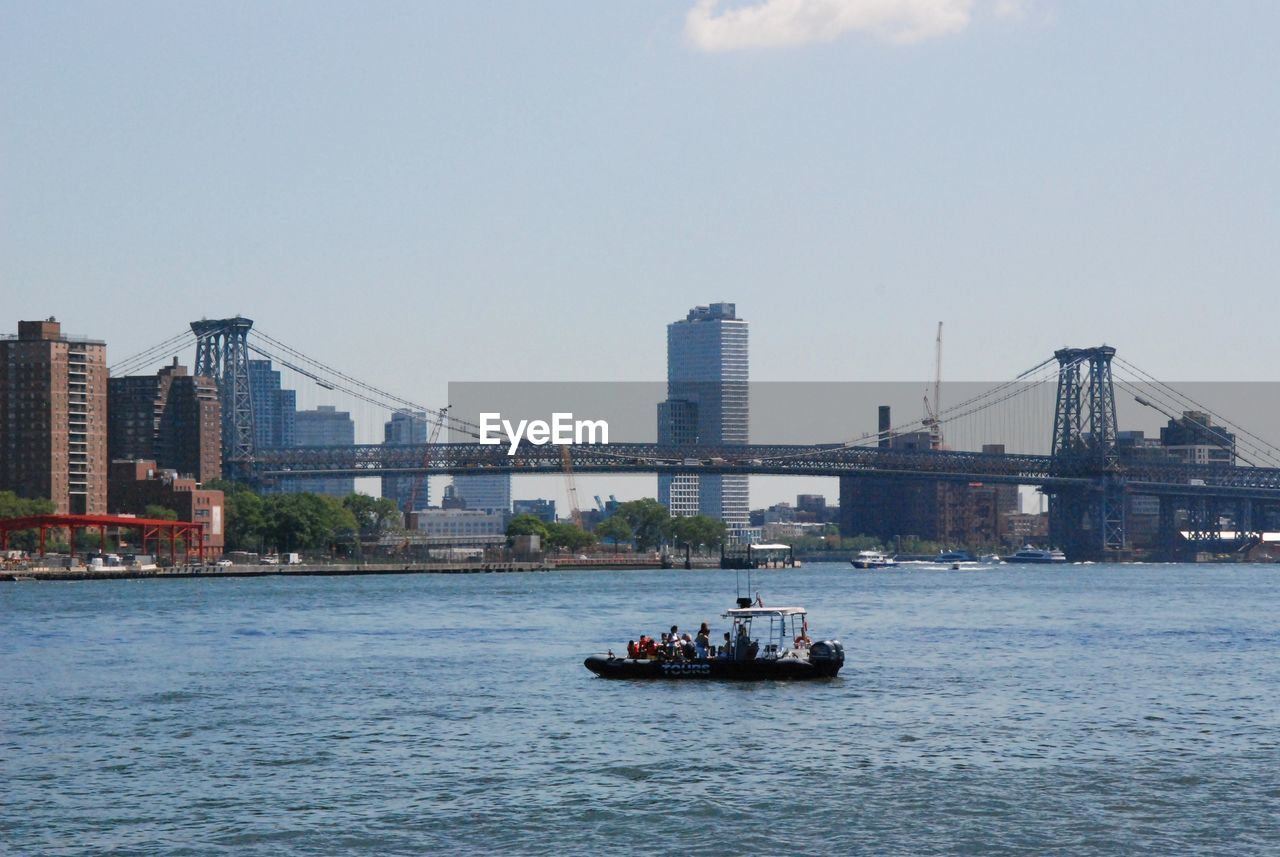 A boat on hudson river right next to brooklyn bridge, new york.