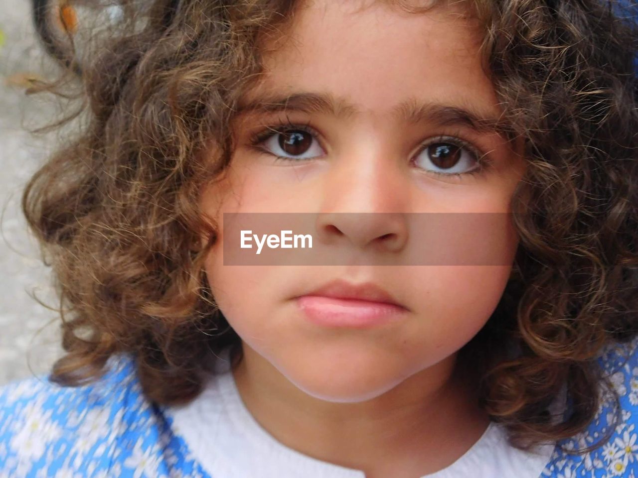 Close-up of cute girl with curly hair