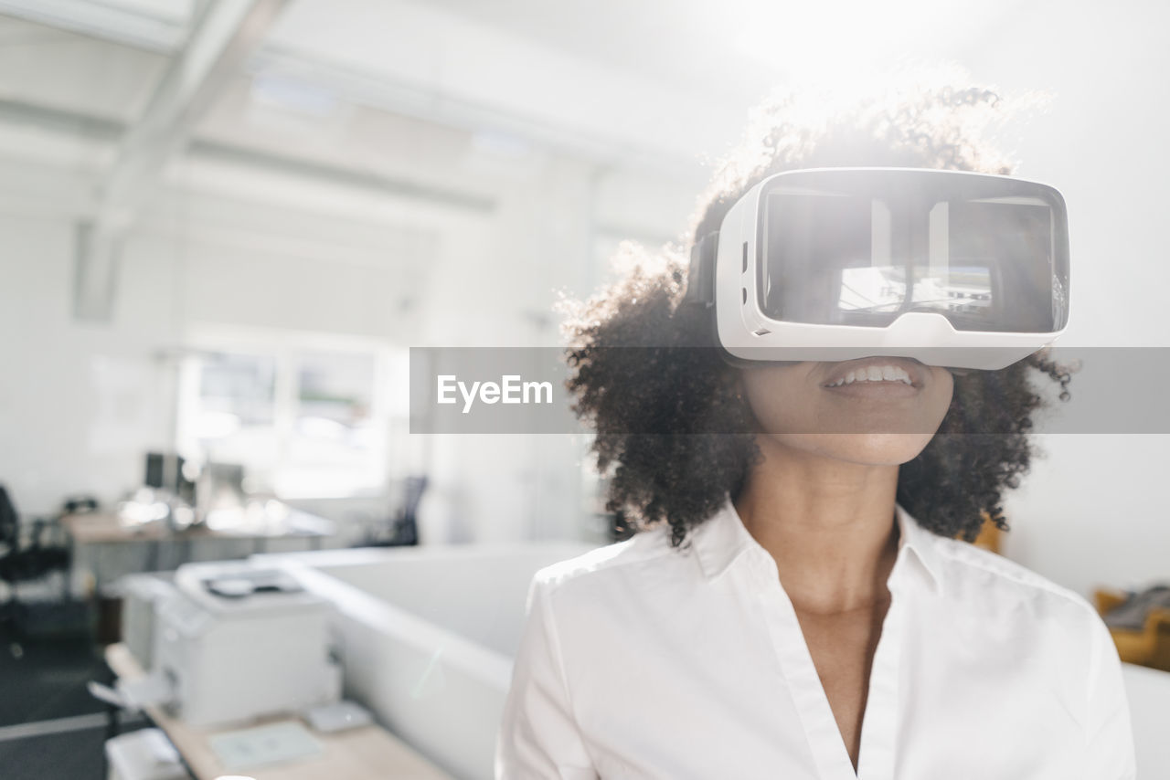 Woman wearing vr glasses in office