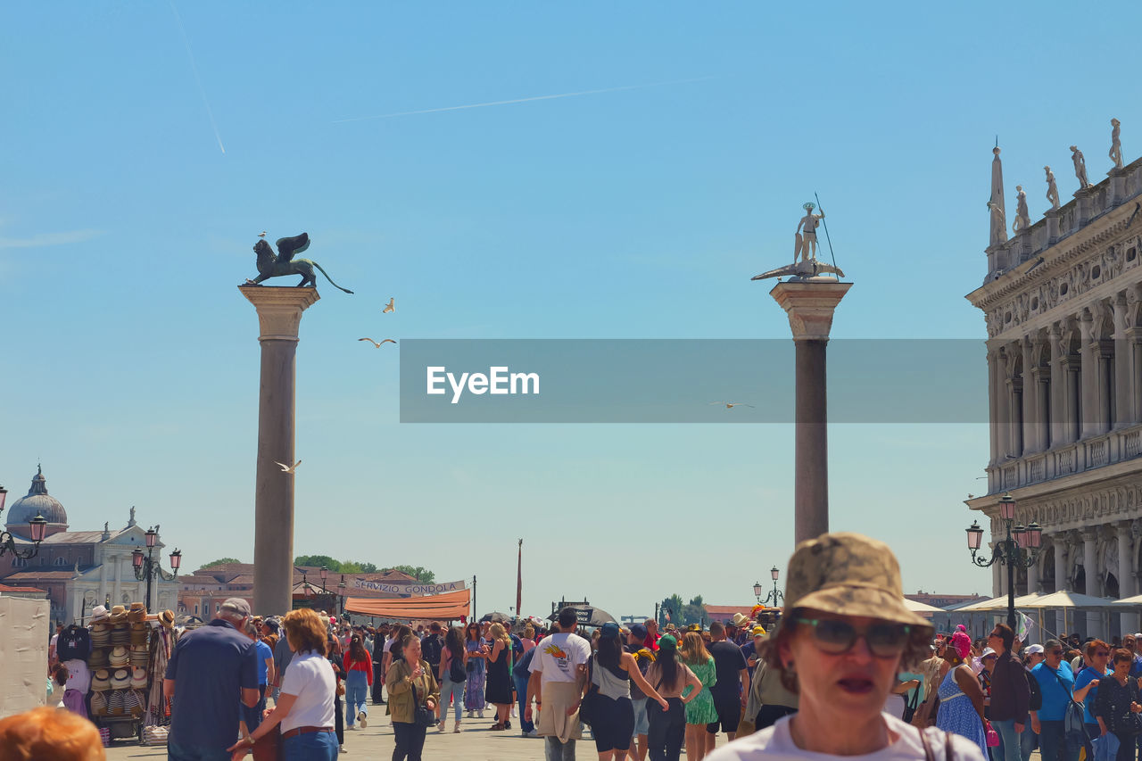 crowd, architecture, large group of people, group of people, travel destinations, built structure, sky, city, building exterior, travel, tourism, men, nature, tourist, adult, history, person, day, lifestyles, the past, clear sky, clothing, women, street, leisure activity, outdoors, blue, tower