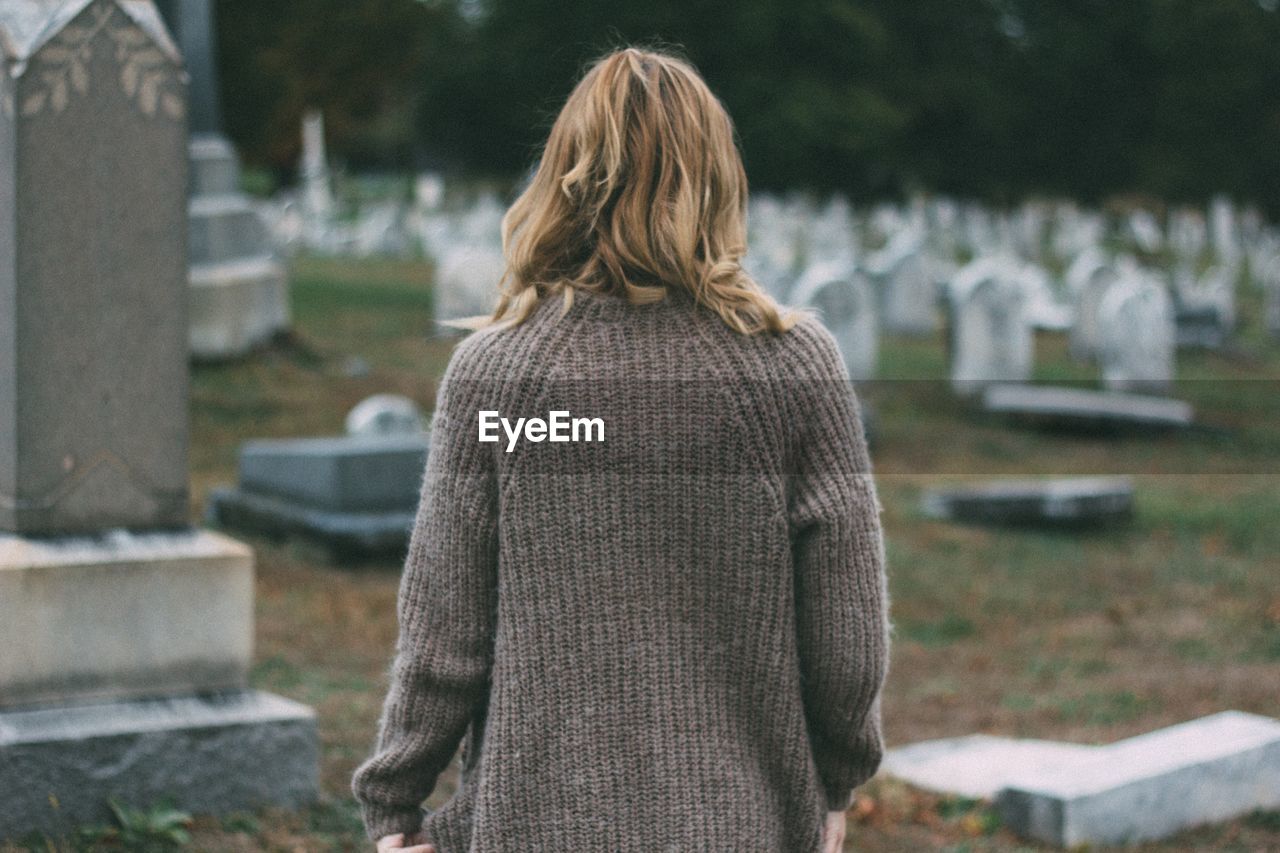 Rear view of woman at cemetery