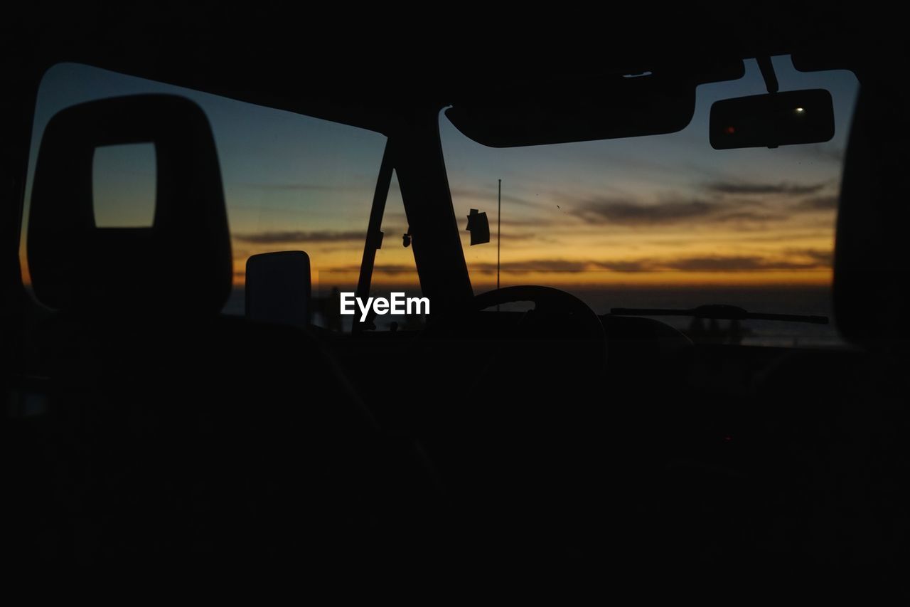 Interior of silhouette van during sunset