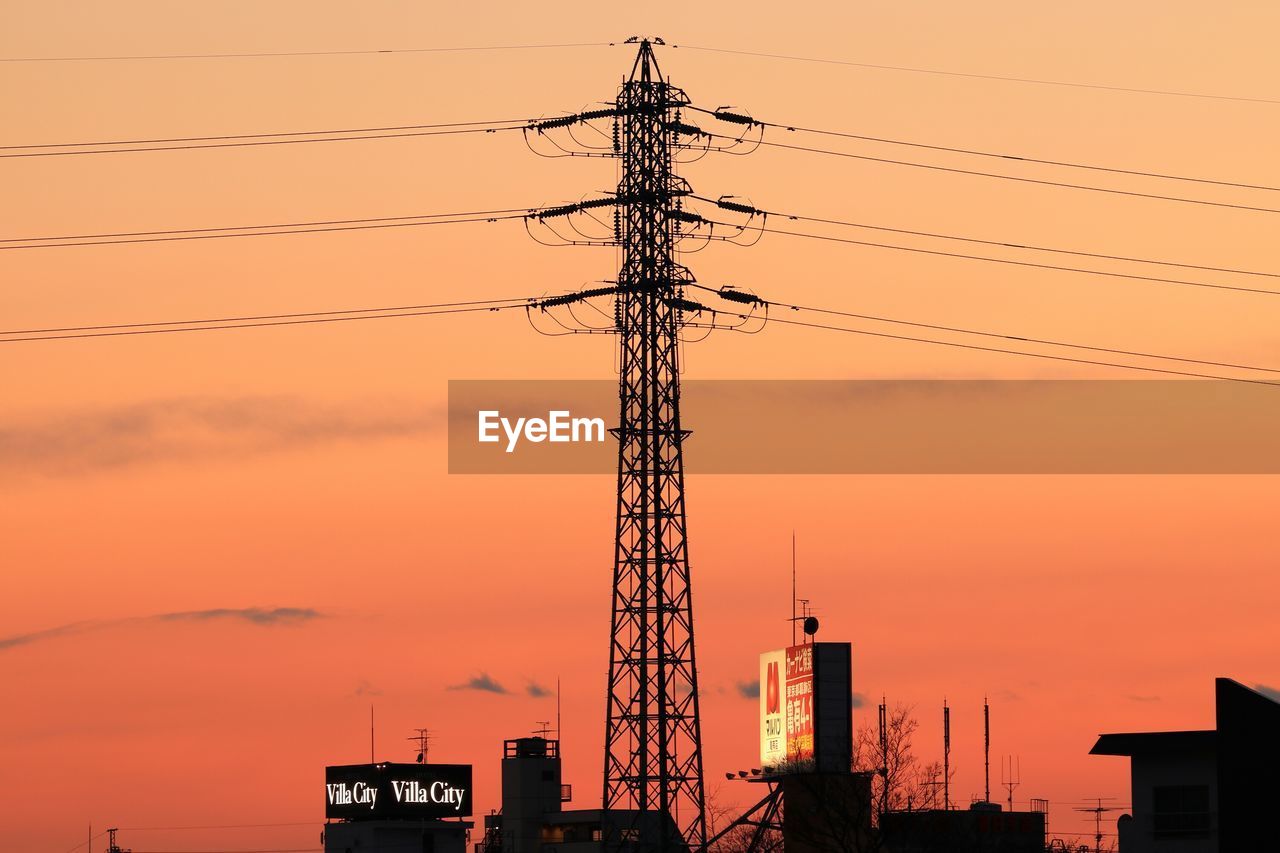 Low angle view of silhouette electricity pylon against sky during sunset