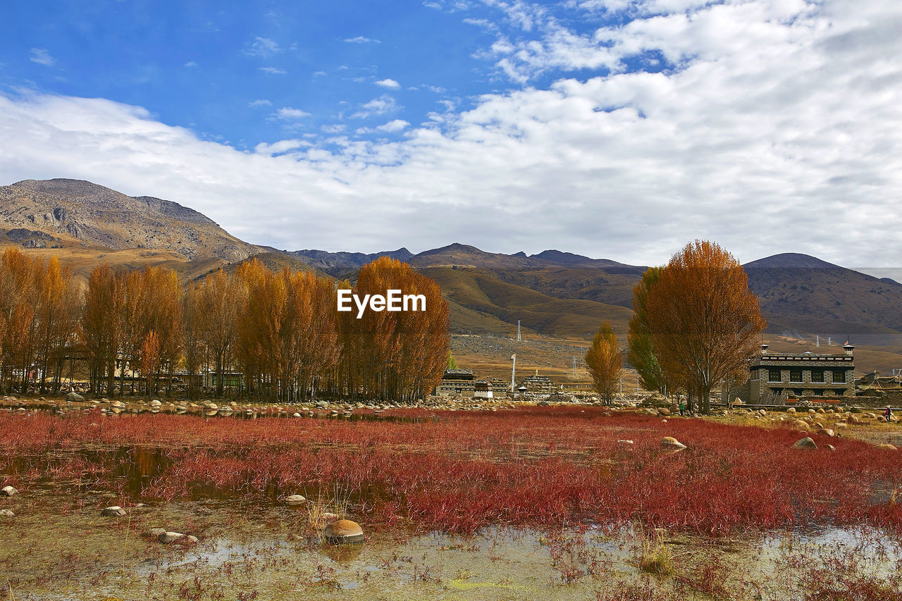 Scenic view of mountains against cloudy sky