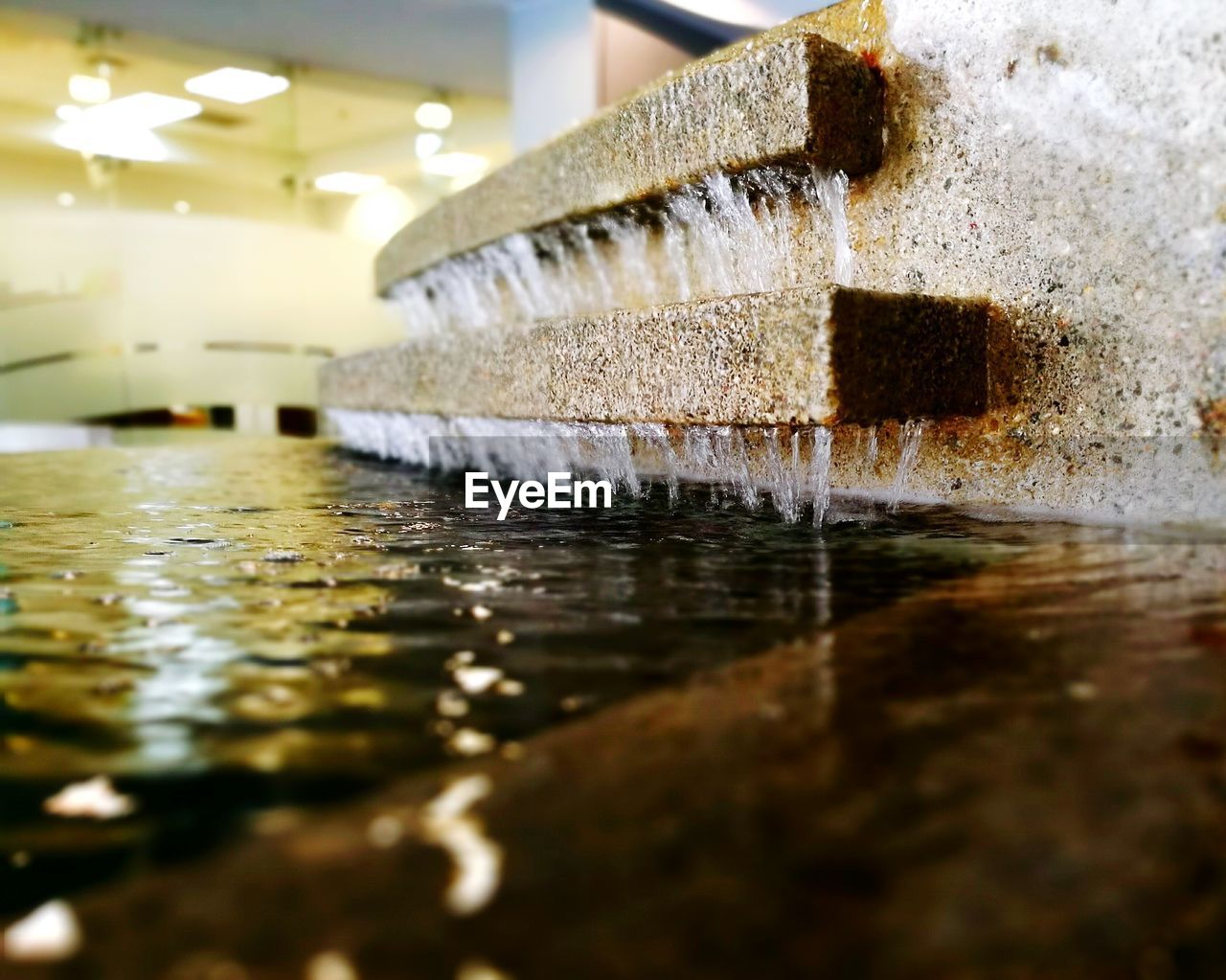 CLOSE-UP OF WATER SPLASHING IN GLASS