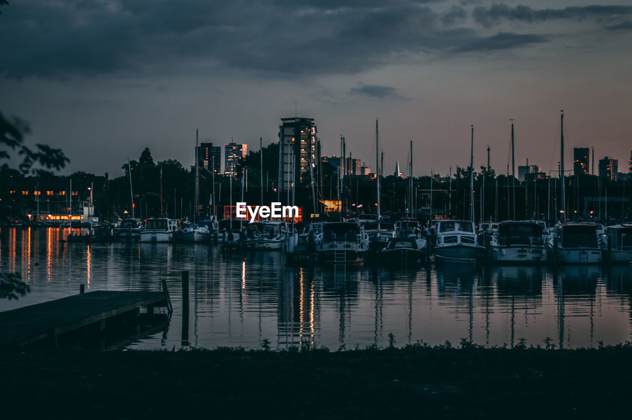 Sailboats in marina at sunset