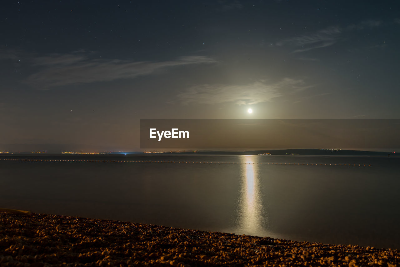 Scenic view of the full moon over rijeka over the sea against clear sky at night