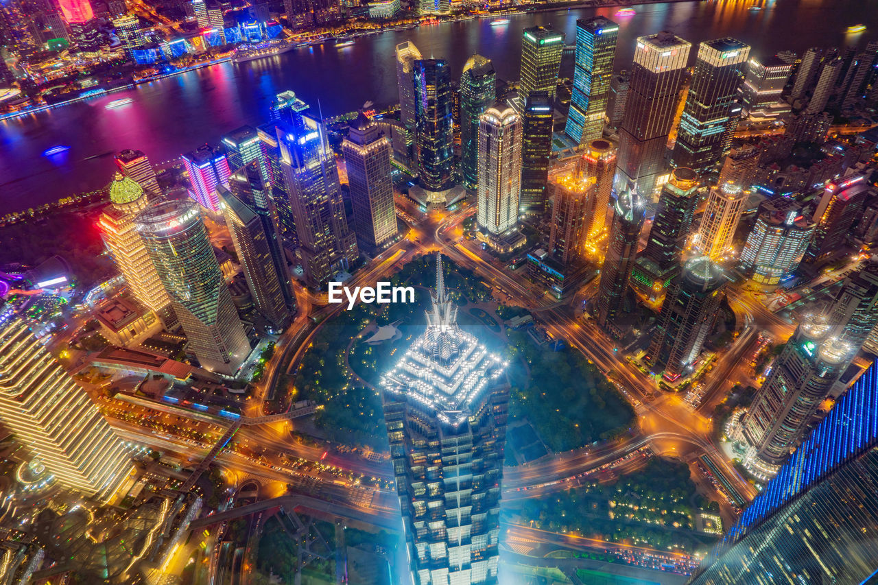 HIGH ANGLE VIEW OF ILLUMINATED CITY BUILDINGS