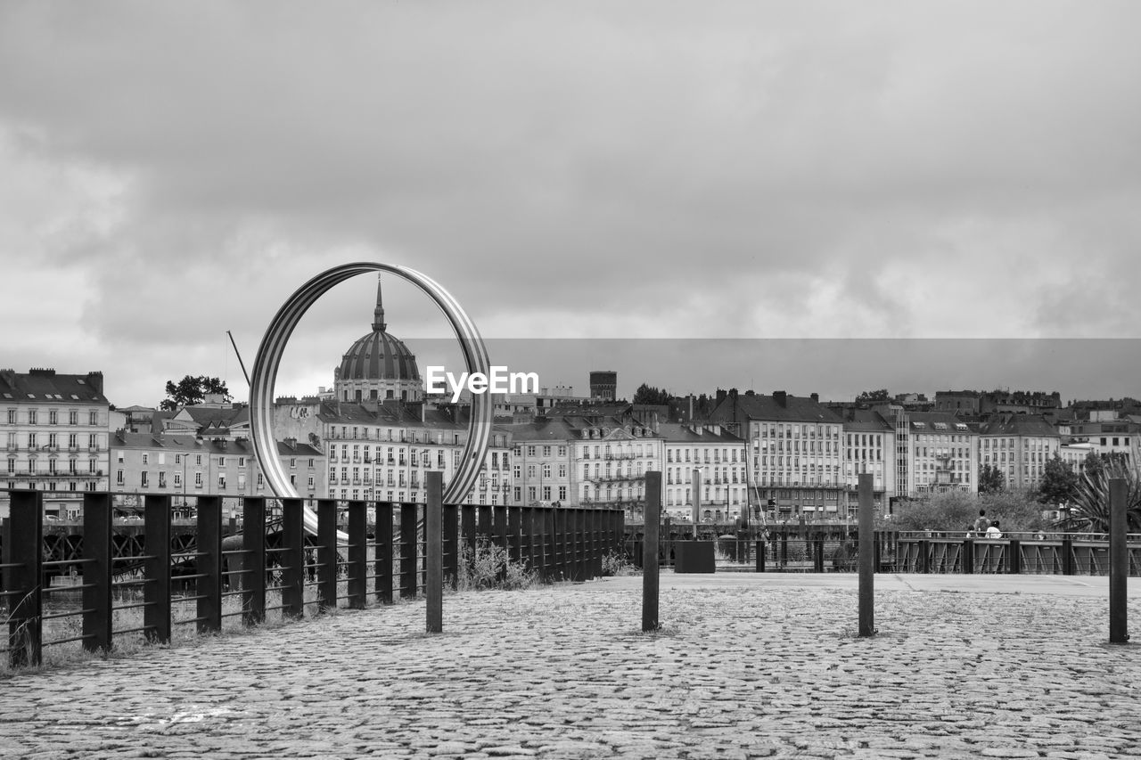 architecture, sky, built structure, black and white, cityscape, monochrome, nature, monochrome photography, cloud, city, building exterior, water, pier, travel destinations, landmark, day, outdoors, beach, horizon, amusement park ride, no people, amusement park, urban area, playground, sea, ferris wheel, tourism