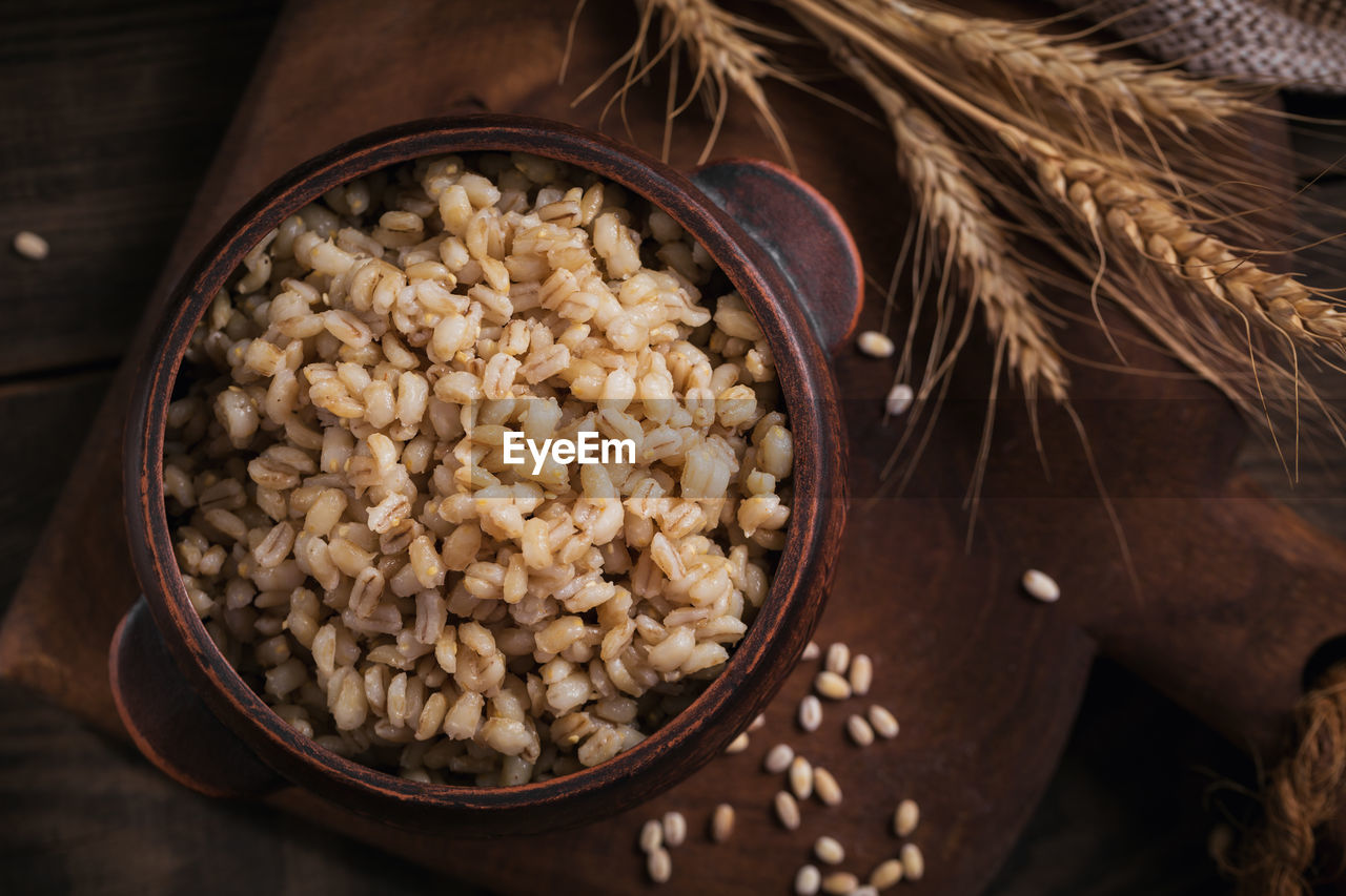 Bowl of cooked peeled barley grains porridge