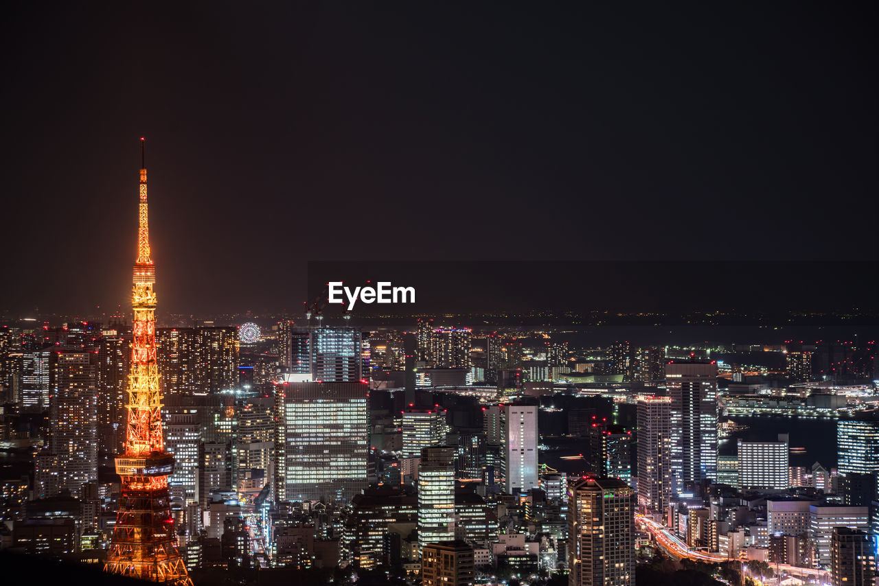 ILLUMINATED BUILDINGS AGAINST SKY AT NIGHT