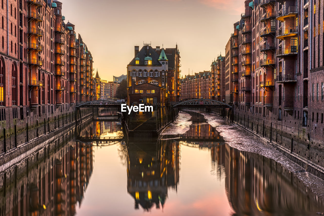 Bridge over canal amidst buildings in city