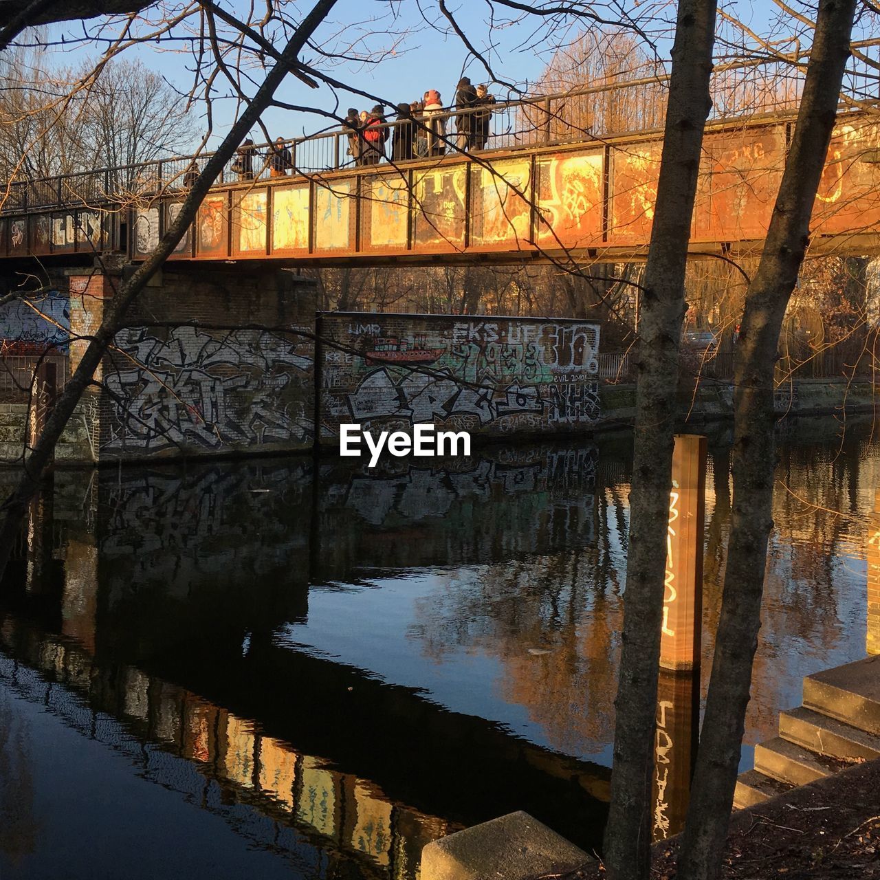 REFLECTION OF BRIDGE IN RIVER