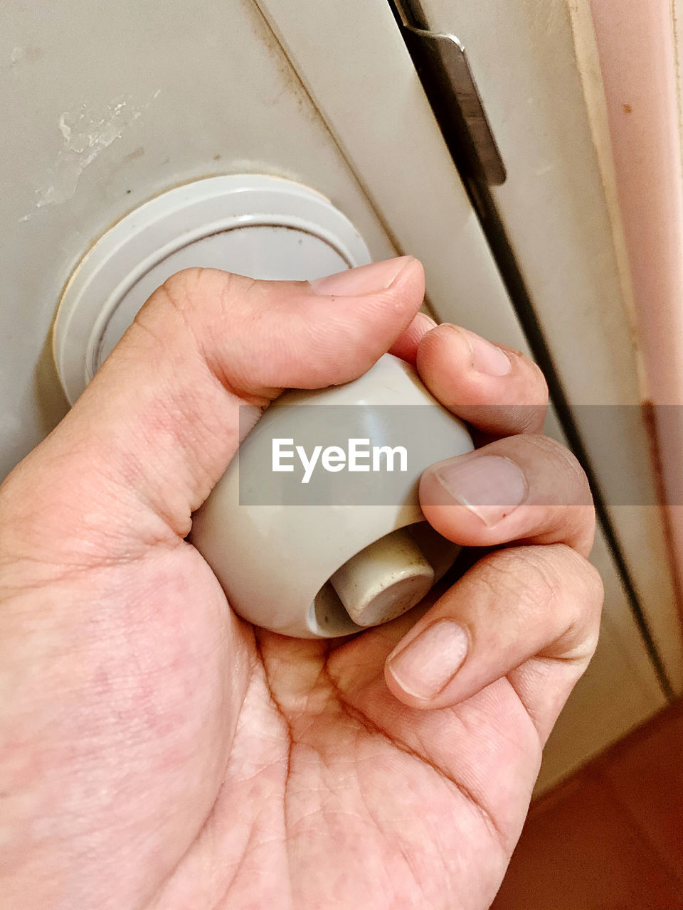 Cropped hand holding doorknob