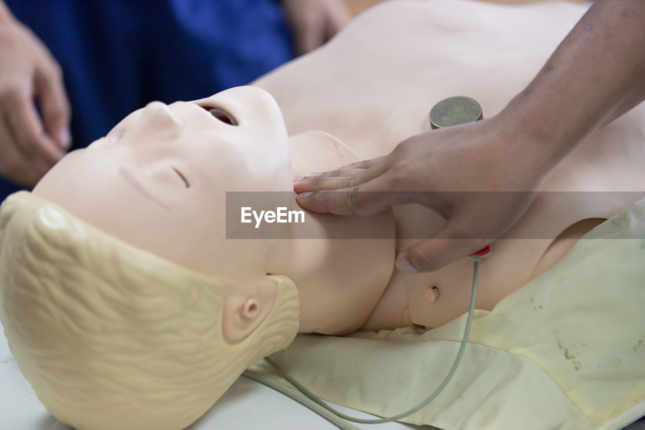 Cropped image of person learning cpr in hospital