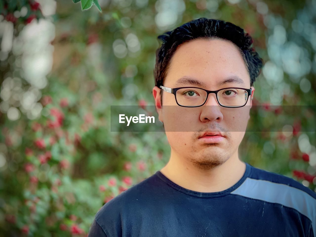 PORTRAIT OF YOUNG MAN WITH EYEGLASSES