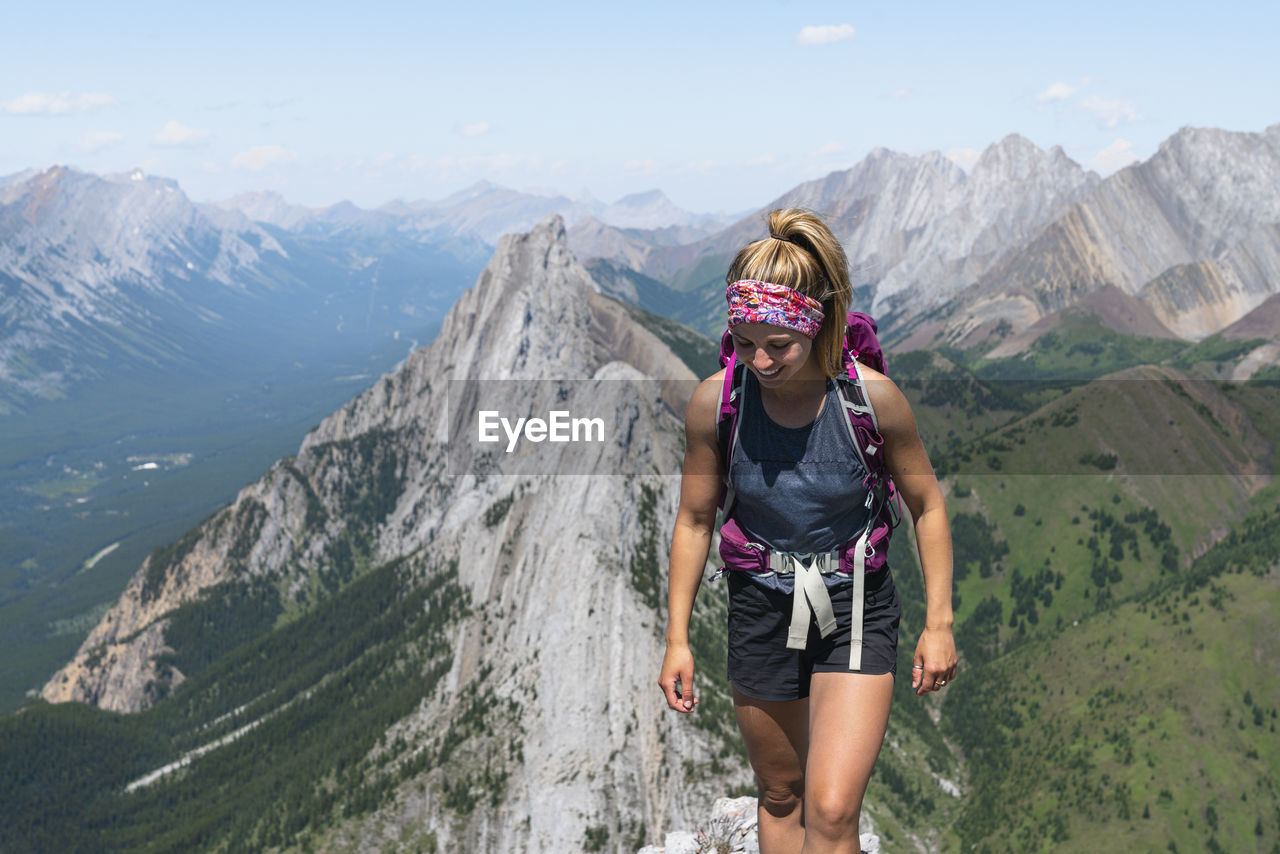 Female hiking along rocky ridge in alberta's kananaskis country