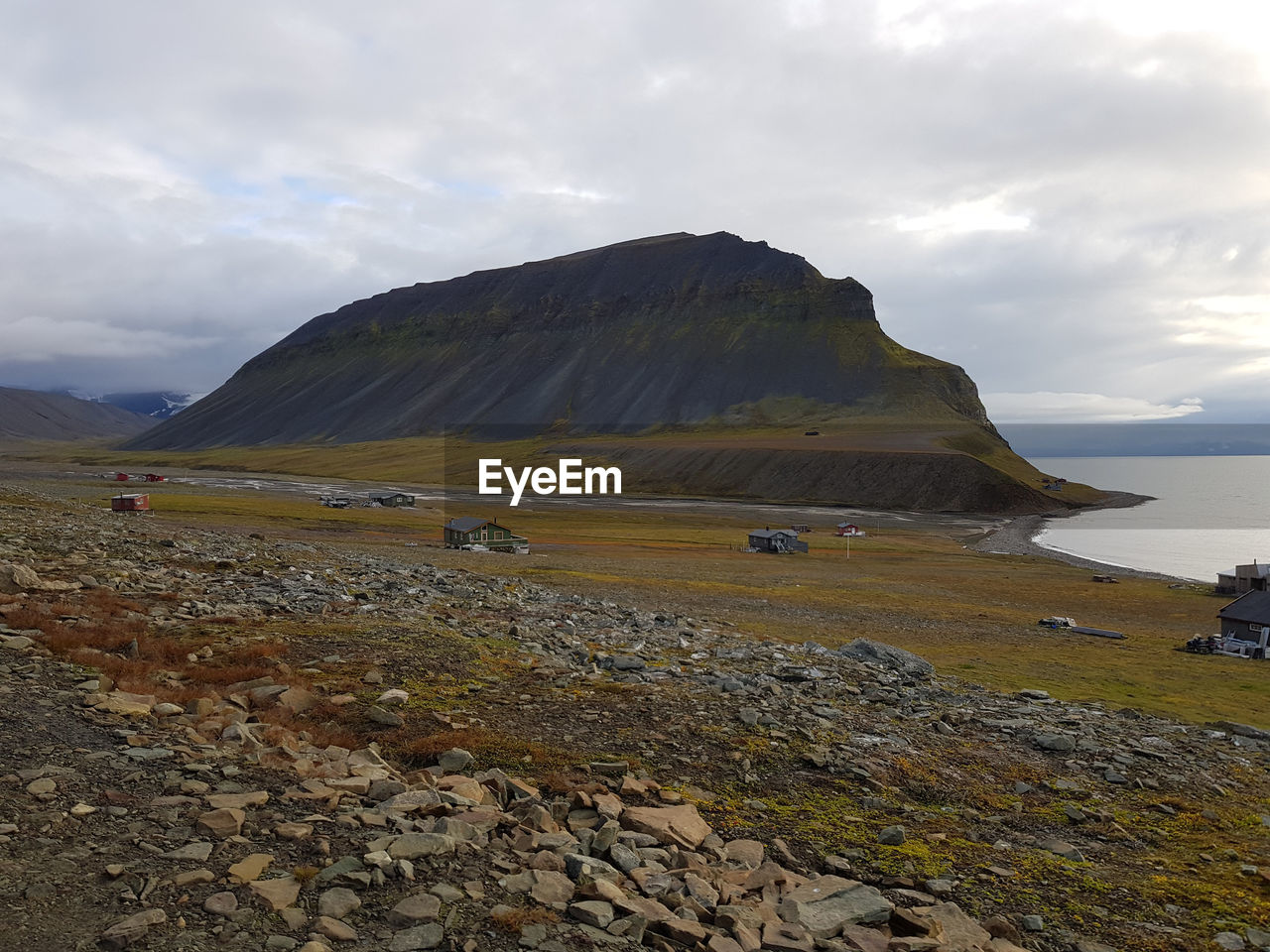 Scenic view of sea and mountains against sky