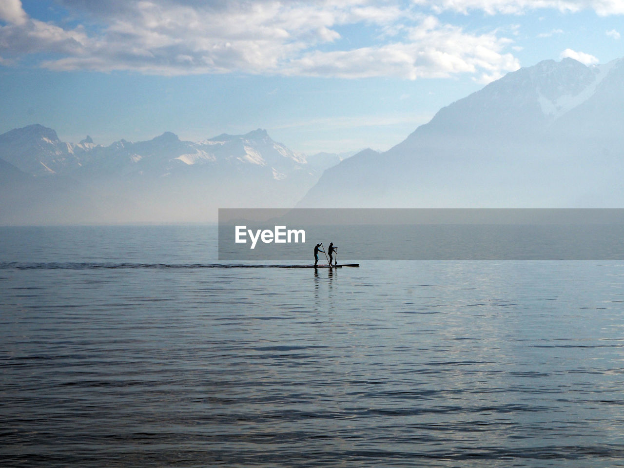 People paddleboarding in lake geneva