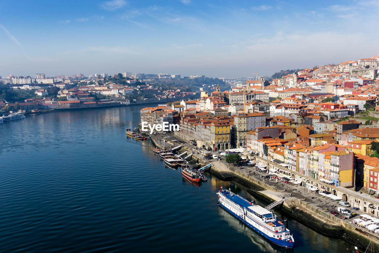 High angle view of river by cityscape against sky