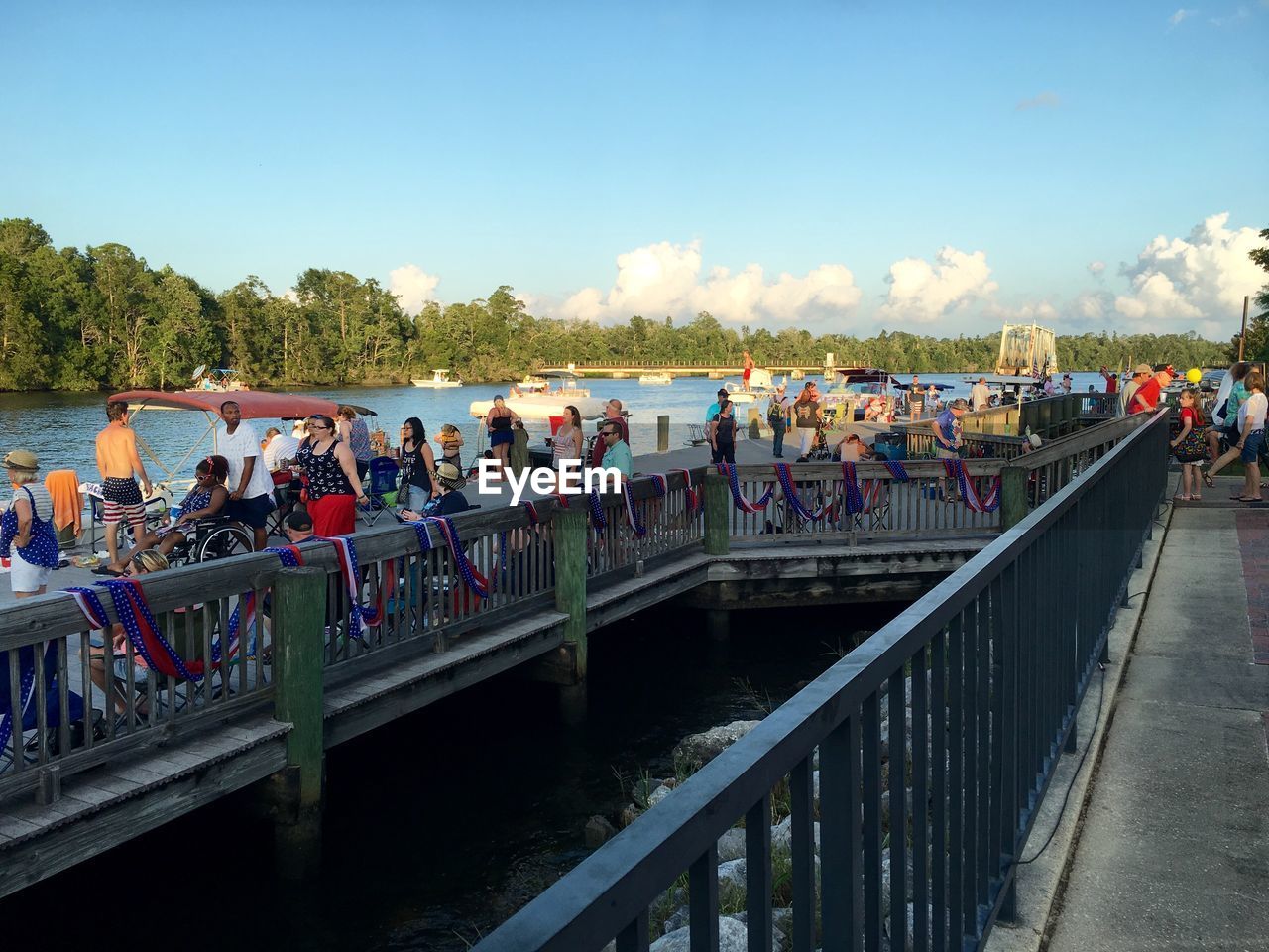 TOURISTS ON BRIDGE OVER RIVER