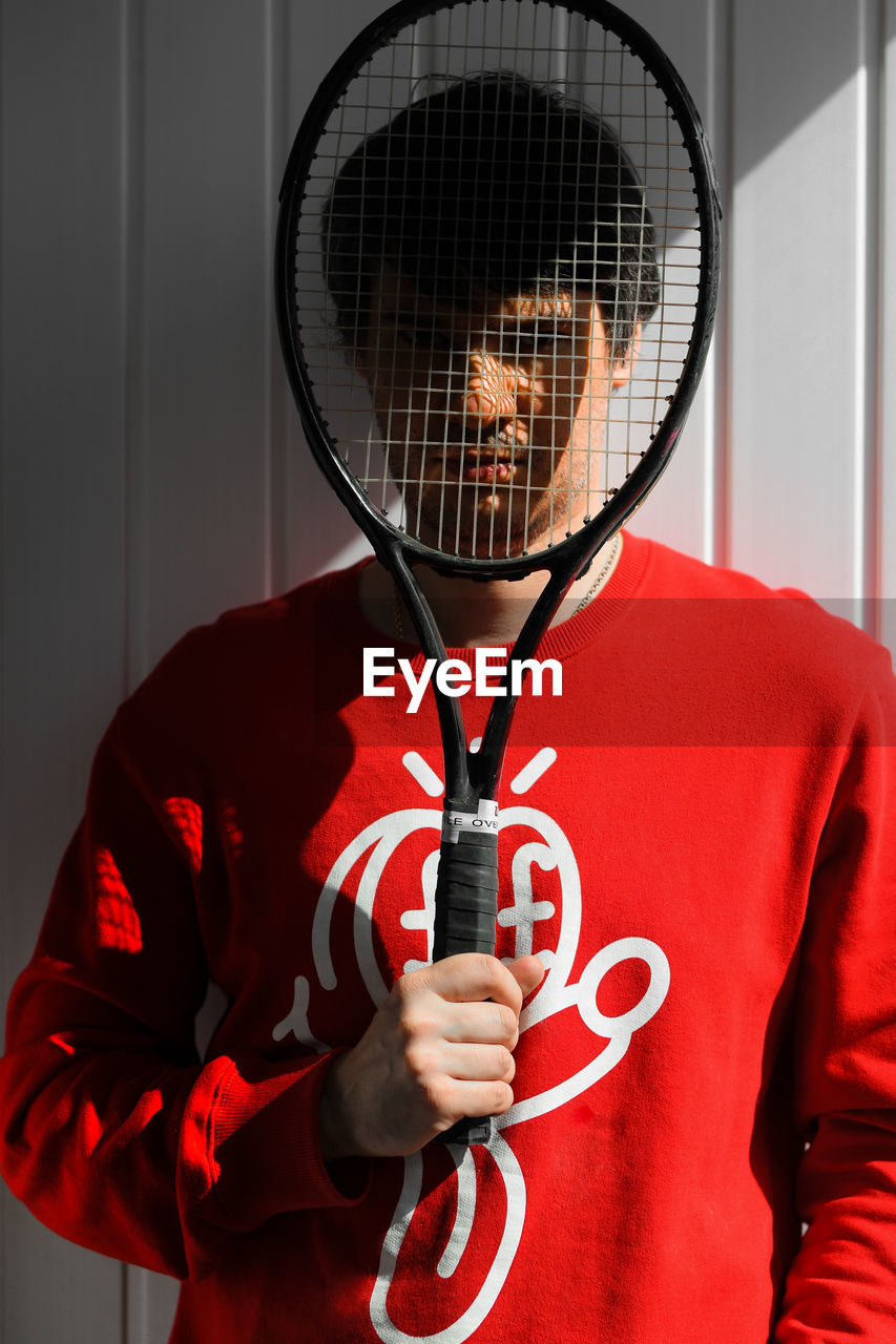 FULL LENGTH PORTRAIT OF PERSON HOLDING RED WHILE STANDING ON MIRROR