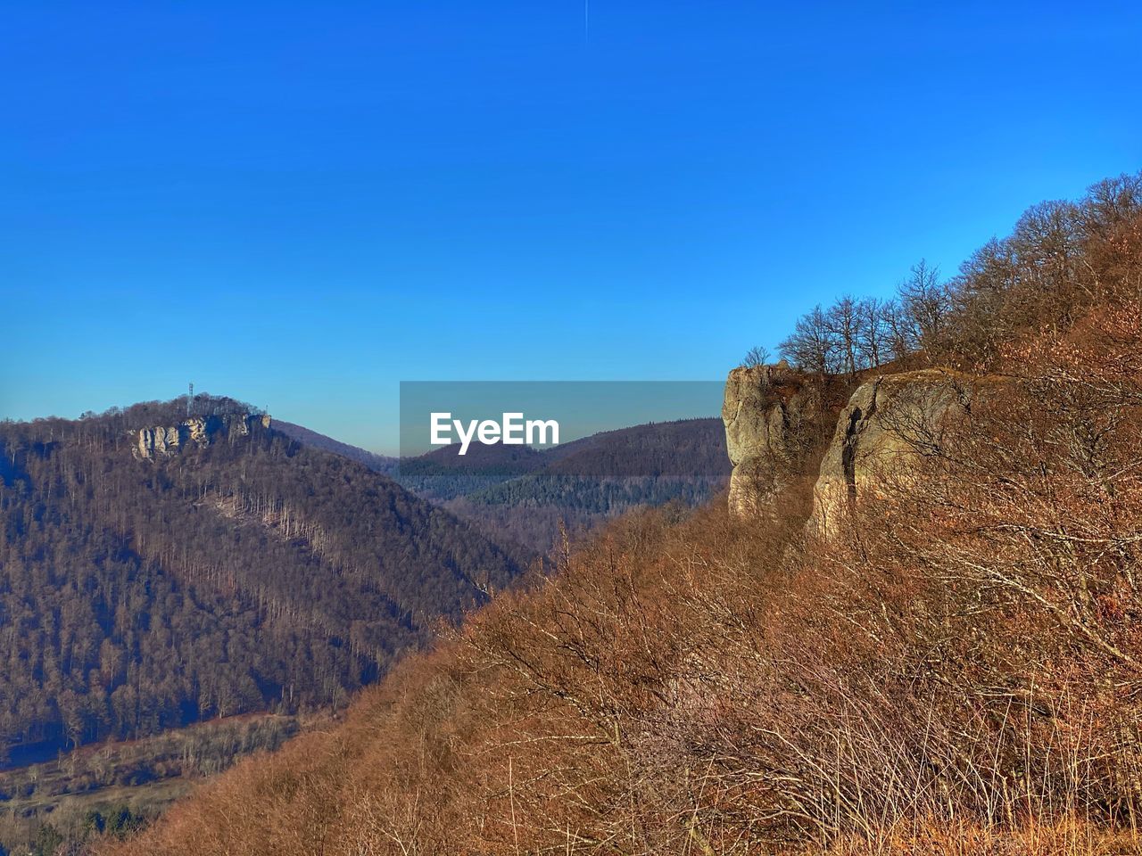 Scenic view of mountains against clear blue sky