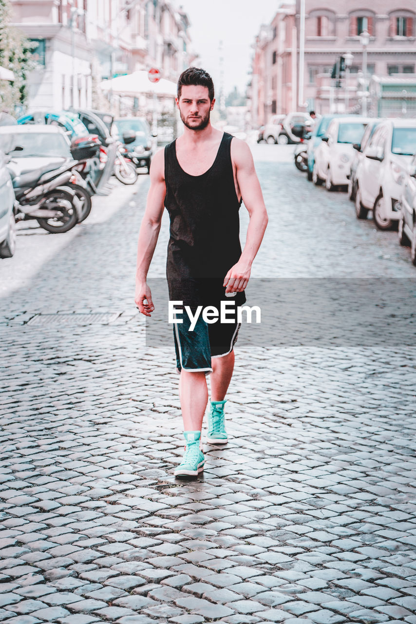 PORTRAIT OF MAN STANDING ON STREET