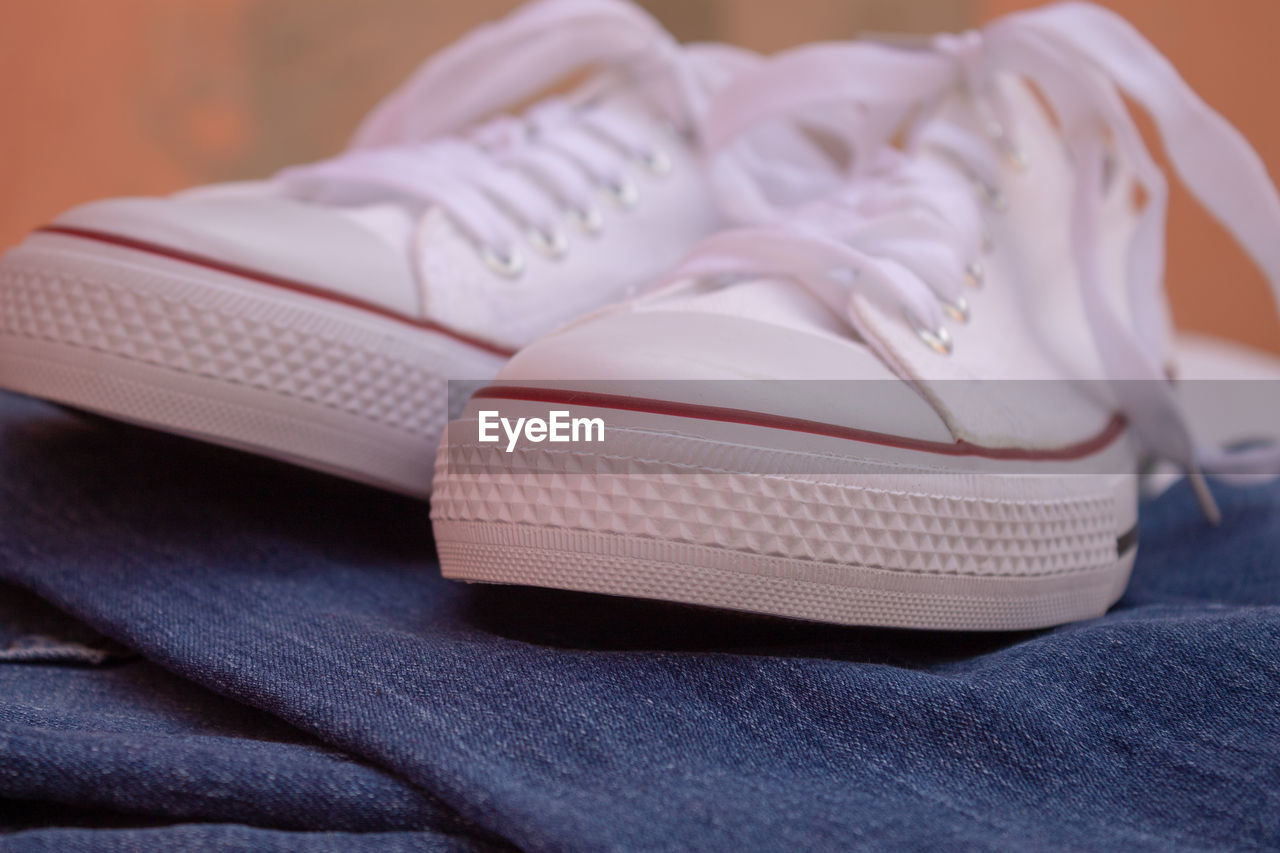 CLOSE-UP OF SHOES ON BLUE TABLE