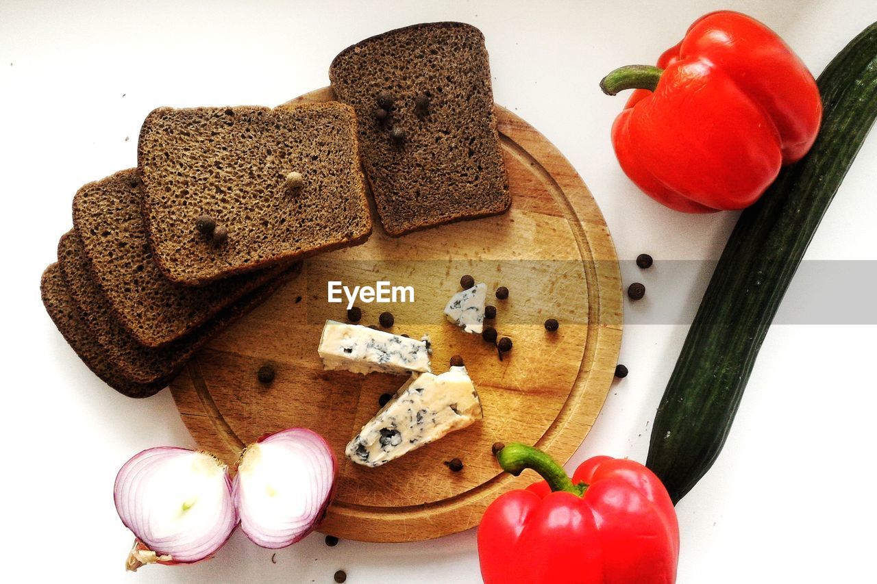 Directly above shot of breads and ingredients on cutting board