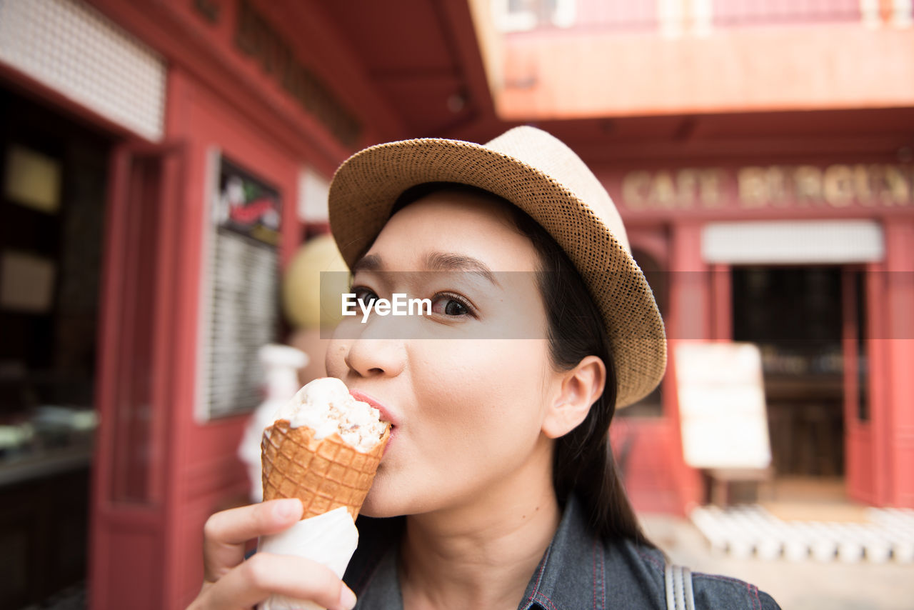 Portrait of mid adult woman eating ice cream