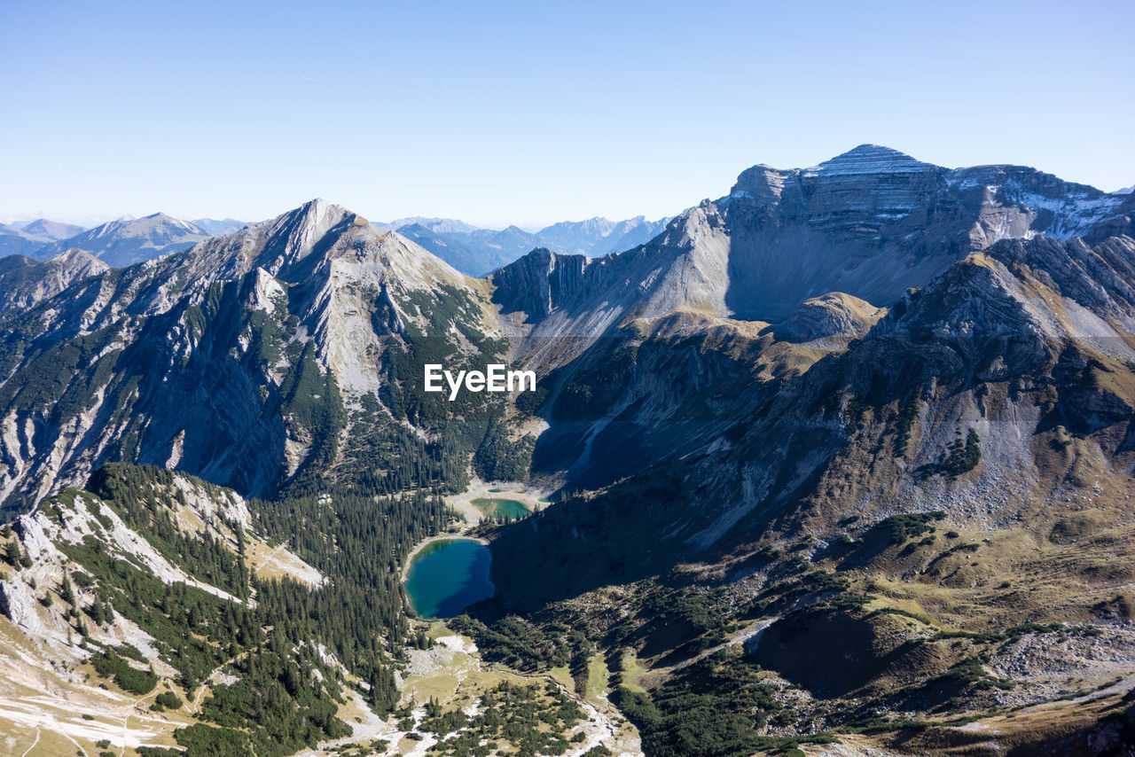 Scenic view of mountains against clear blue sky