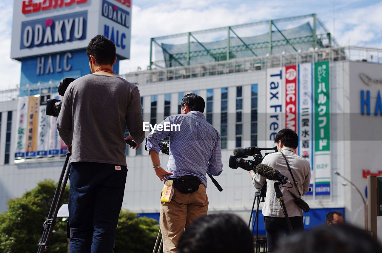 Rear view of photographers