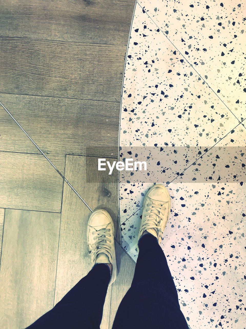 low section, human leg, shoe, one person, personal perspective, standing, lifestyles, flooring, human foot, human limb, limb, high angle view, adult, footwear, indoors, leisure activity, men, tile, directly above, pattern, day, white, tiled floor
